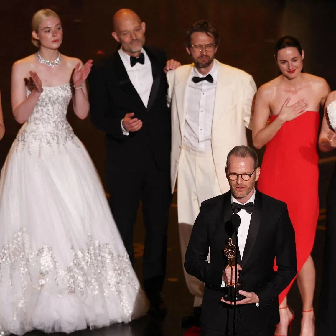 Joachim Trier accepts the award for Best International Feature Film for Sentimental Value alongside (back, from left) Norwegian producer Maria Ekerhov, US actress Elle Fanning, Norwegian screenwriter Eskil Vogt, Norwegian actor Anders Danielsen Lie, Norwegian actress Renate Reinsve and Norwegian actress Inga Ibsdotter Lilleaas onstage during the 98th Annual Academy Awards on March 15.