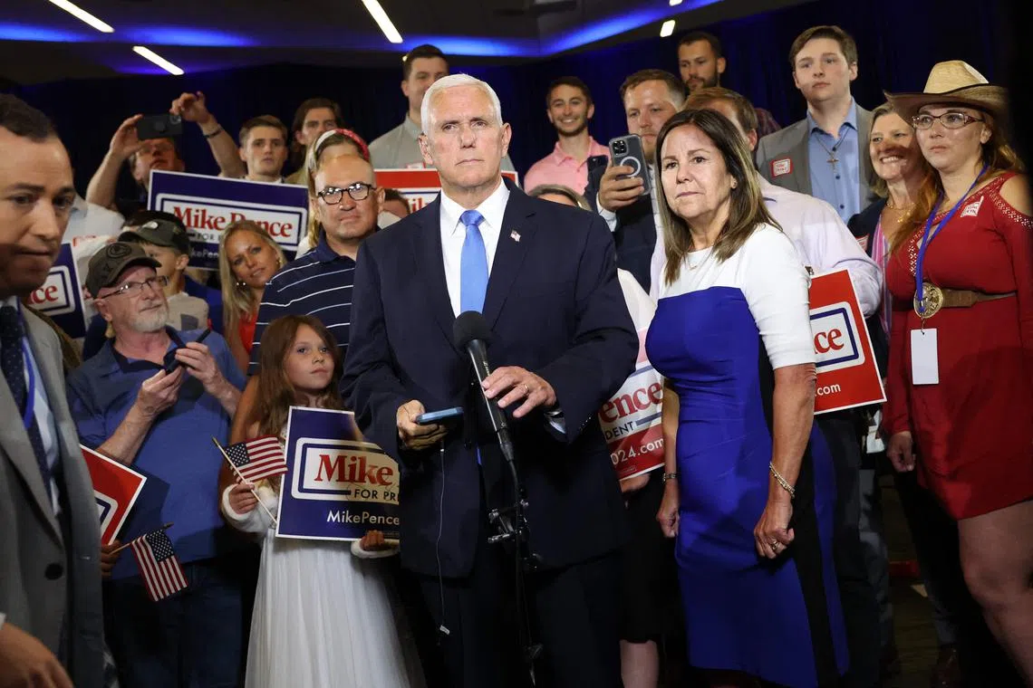 Former vice-president Mike Pence, joined by his wife Karen, takes part in a TV news interview after formally announcing his intention to seek the Republican nomination for president.