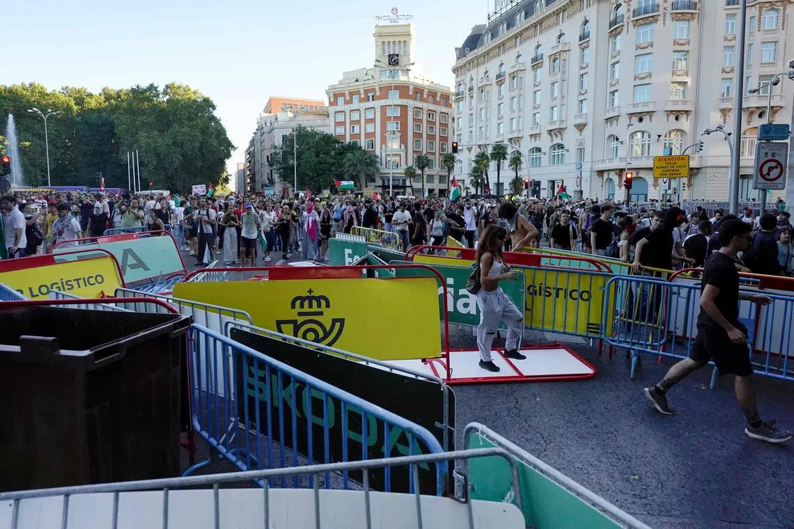 Pro-Palestinians protestors pull barriers and invade the street during the 21st and last stage of the Vuelta a Espana 2025.