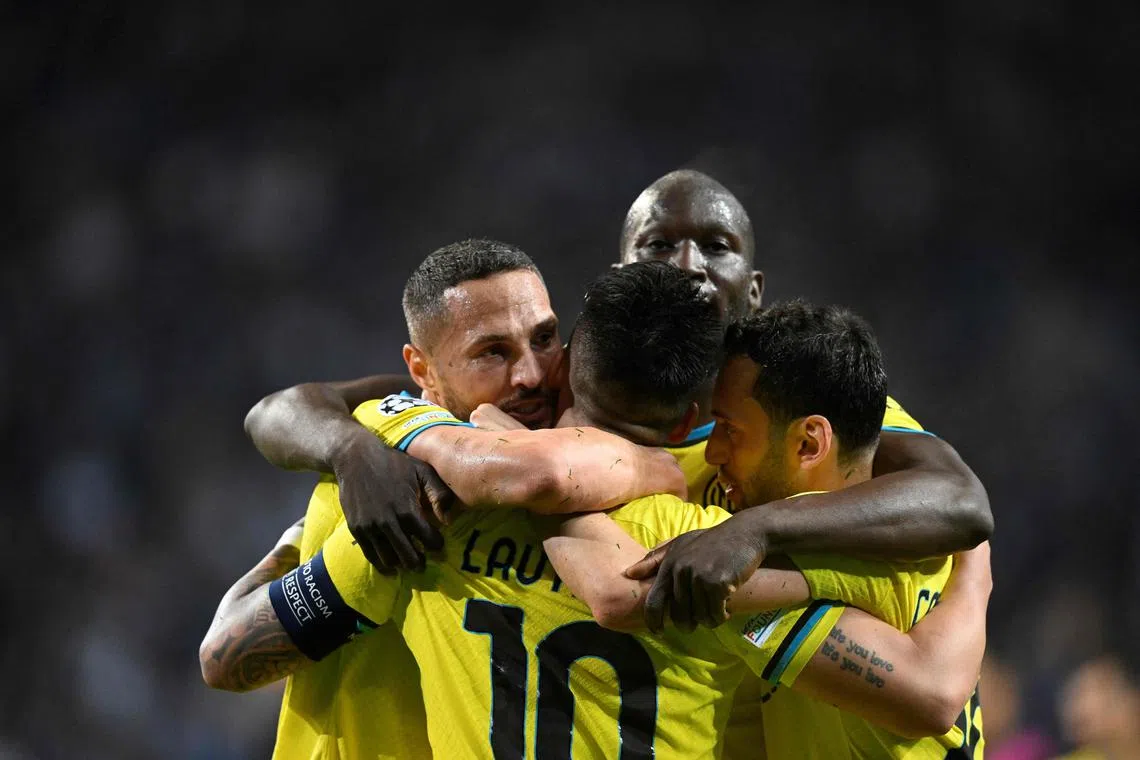 Inter Milan forward Lautaro Martinez (back) and teammates celebrate at the end of the Champions League last-16 second-leg match against Porto. They drew 0-0 to advance on a 1-0 aggregate. 