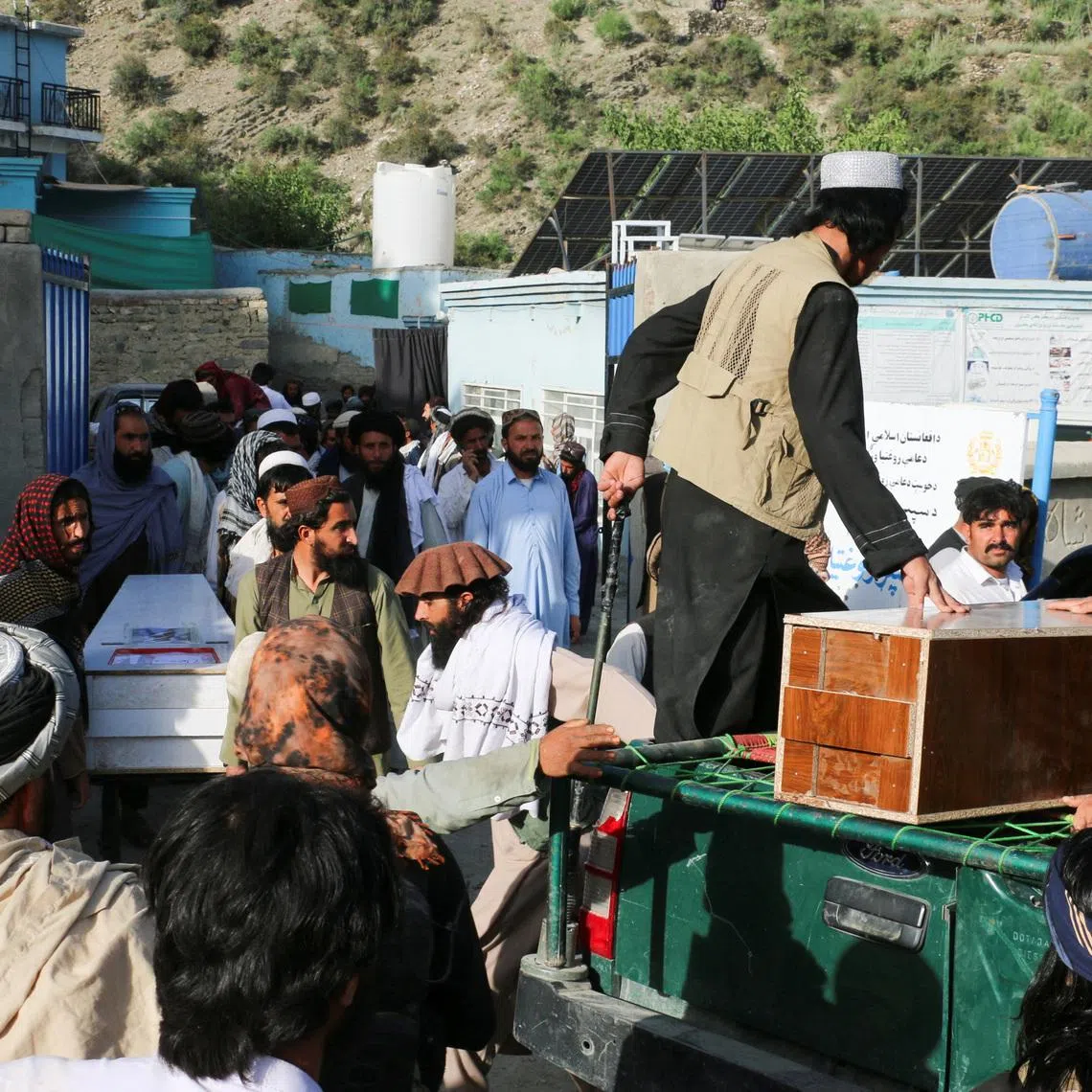 People gather near coffins containing the bodies of victims who died in what the Taliban said was a Pakistani airstrike in Mani village, Spera District, Khost Province, Afghanistan, June 10, 2026. REUTERS/Stringer