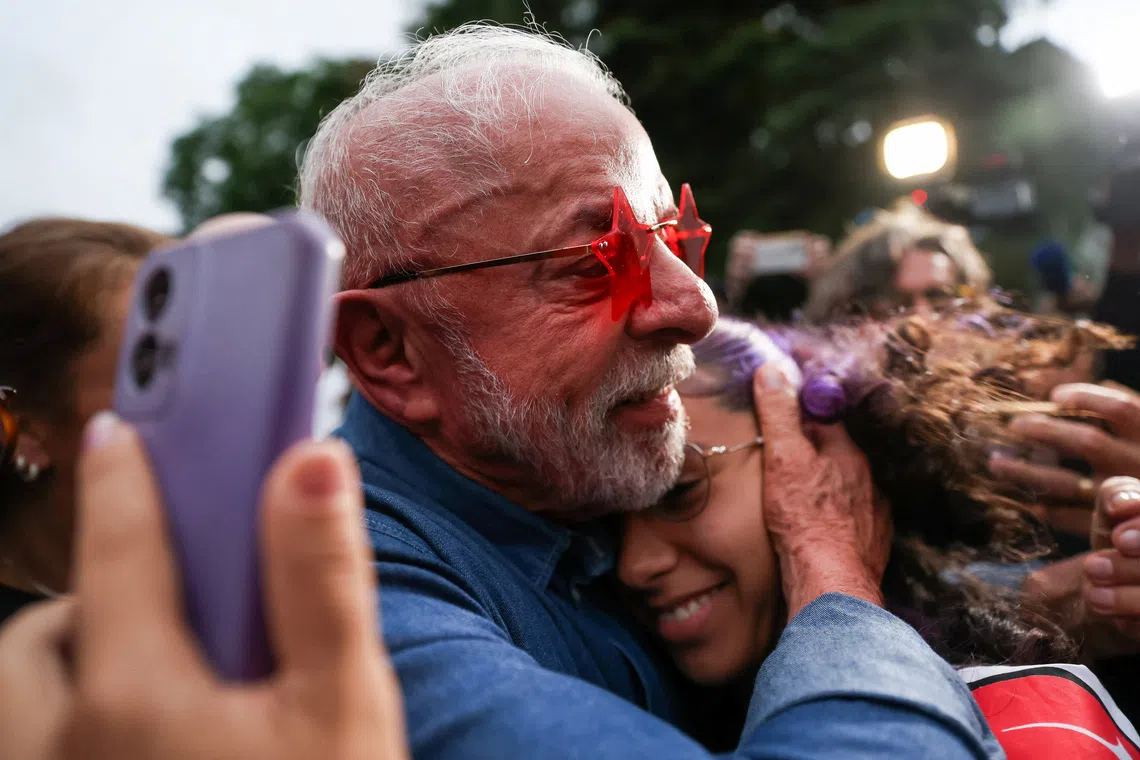 Brazilian President Luiz Inacio Lula da Silva, the Workers' Party (PT) candidate for presidential re-election, embraces a supporter outside his residence on the day of the presidential runoff election, in Sao Paulo, Brazil, October 25, 2026. REUTERS/Tuane Fernandes