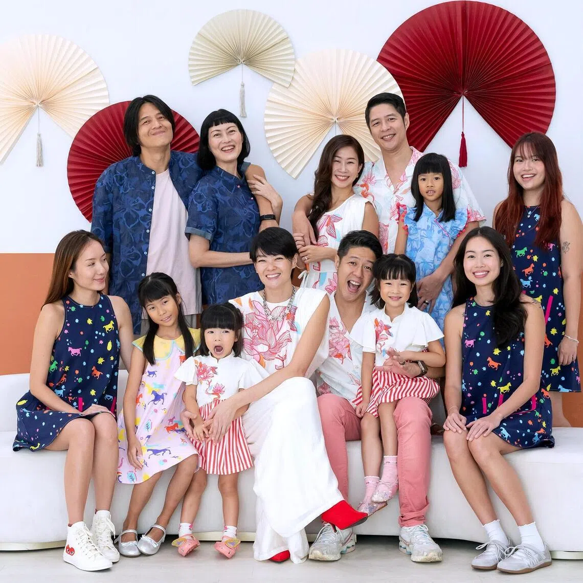Sheila Sim with her family and friends in matching outfits that she designed in partnership with Le Petit Society.