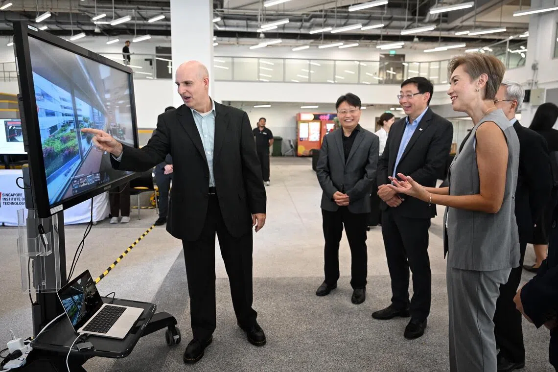 Minister for Digital Development and Information Josephine Teo being taken on a virtual tour of the SIT x Nvidia AI Centre by Professor Ian McLoughlin from the Singapore Institute of Technology at the official opening of the centre on Oct 2. 