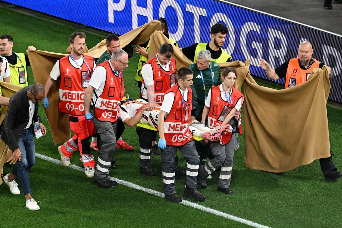FILE PHOTO: Soccer Football - Euro 2024 - Group A - Scotland v Hungary - Stuttgart Arena, Stuttgart, Germany - June 23, 2024 A sheet is put up by stewards as Hungary's Barnabas Varga is stretchered off after sustaining an injury REUTERS/Angelika Warmuth/File Photo