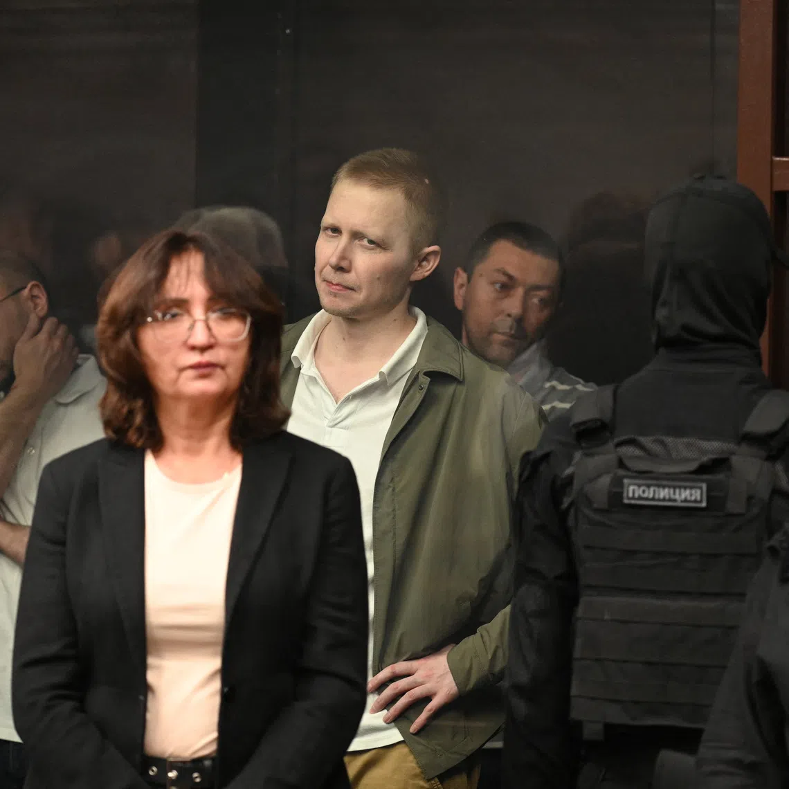 Oleg Antipov and other defendants, accused of involvement in the bomb attack on the Crimean Bridge in October 2022 amid the Russia-Ukraine military conflict, stand behind a glass enclosure during a court hearing in Rostov-on-Don, Russia, November 27, 2025. REUTERS/Sergey Pivovarov