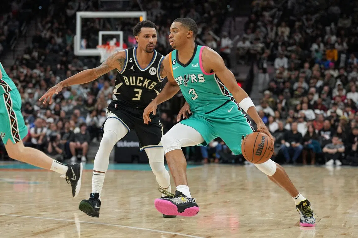 San Antonio Spurs forward Keldon Johnson dribbles against Milwaukee Bucks guard George Hill in the second half at the AT&T Centre.