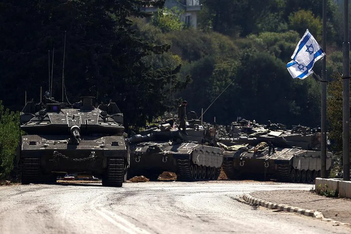 FILE PHOTO: Israeli tanks are seen on a road near Israel's border with Lebanon, in northern Israel, October 12, 2023. REUTERS/Lisi Niesner/File Photo