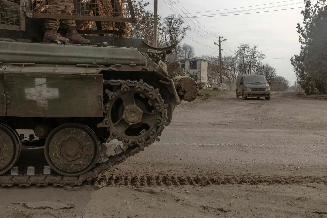 A Ukrainian tank driving on a road in Ukraine's Dnipropetrovsk region, in March 2025.