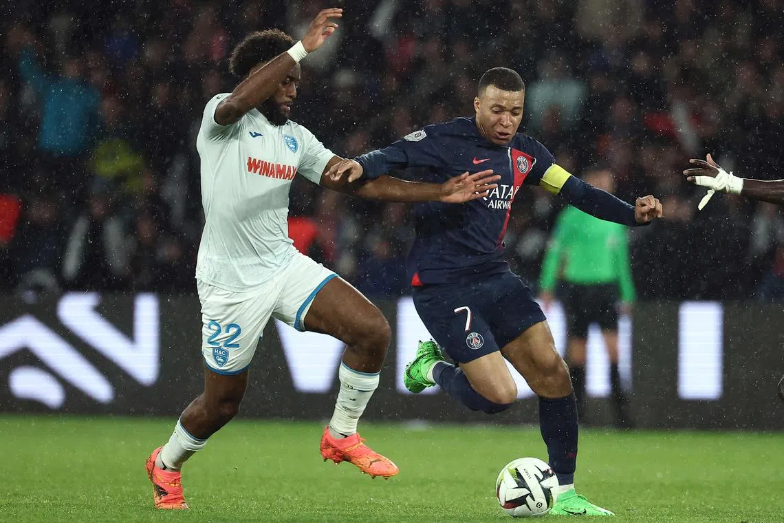 Le Havre's French defender Yoann Salmier (left) vying with Paris Saint-Germain's Kylian Mbappe during the French Ligue 1 match.