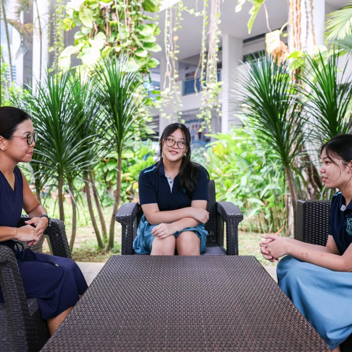 Swiss Cottage Secondary School principal Mandy Cheng (left) engaging Sec 3 students Andi’ Syakirah (right) and Natasha Ng at the school on Sept 18.