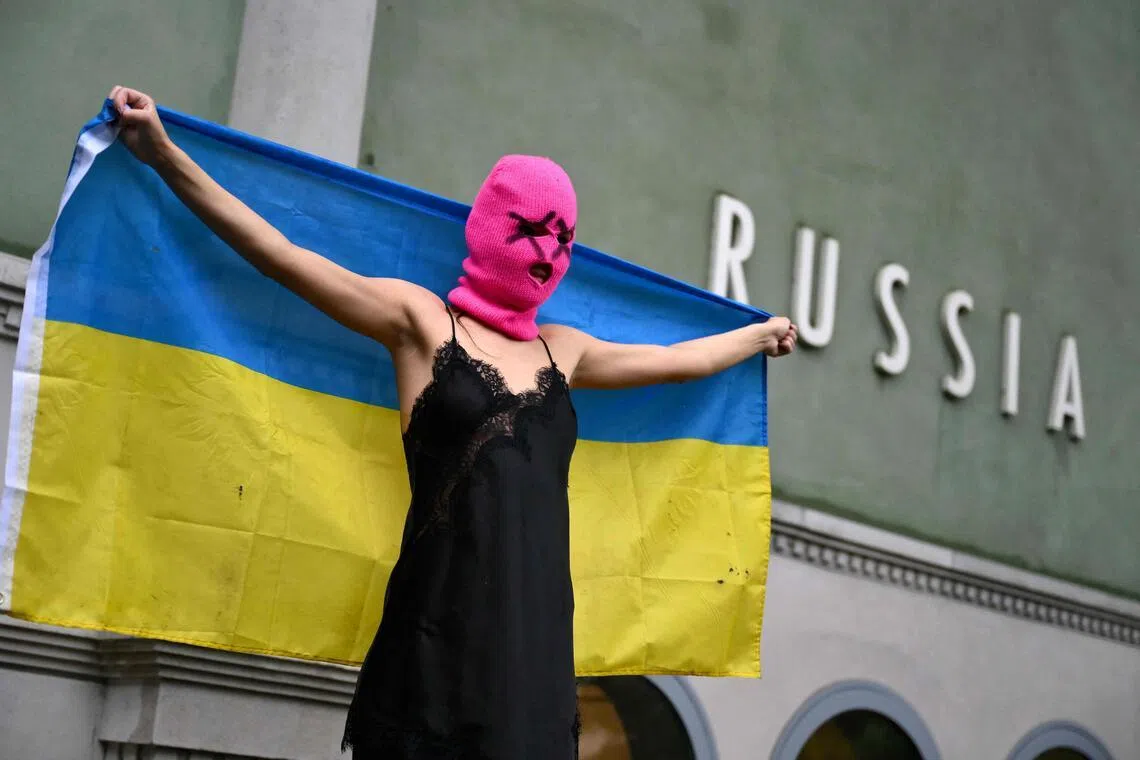 An activist holding a Ukrainian flag protesting on May 6 in front of the Russia pavilion at the Venice Biennale art show.