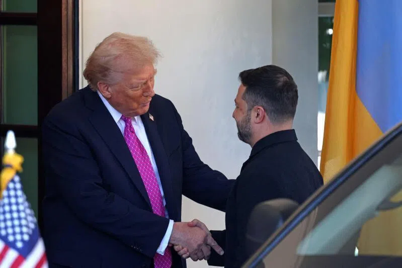 US President Donald Trump welcomes Ukrainian President Volodymyr Zelensky as he arrives for a meeting at the White House in Washington DC on Oct 17, 2025.