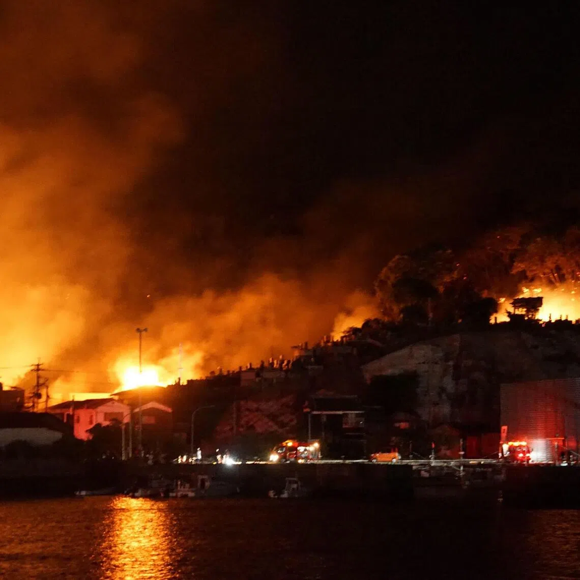 A general view shows the scene of a major fire at a residential area in Saganoseki, Oita City late on November 18, 2025. One person was unaccounted for while 175 others were evacuated as a major fire engulfed a residential area in Japan, the local government said on November 19. (Photo by JIJI Press / AFP) / Japan OUT