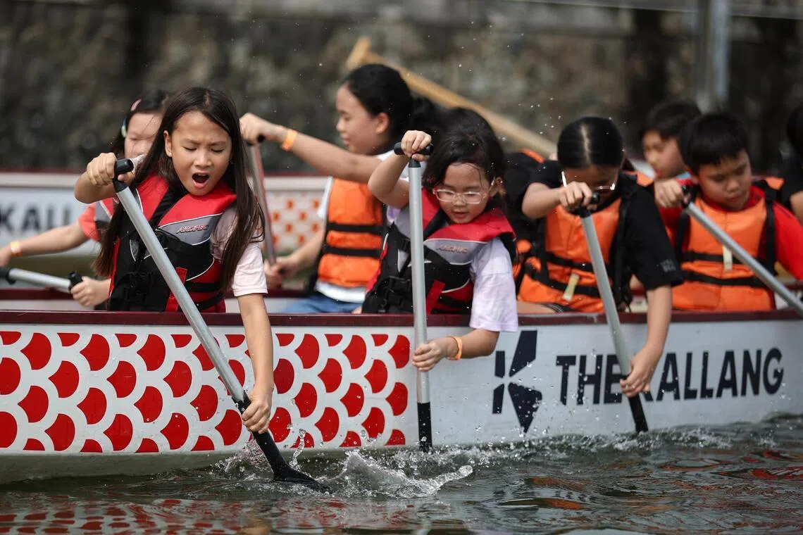 Children try dragon boating at The Kallang’s June holiday aquatics camp at the Water Sports Centre.