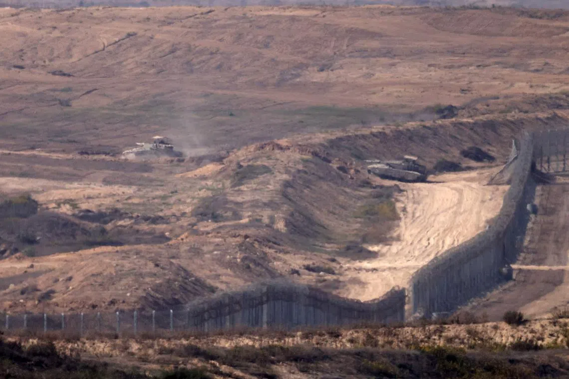Israeli army vehicles crossing the border into Gaza, on Nov 6.