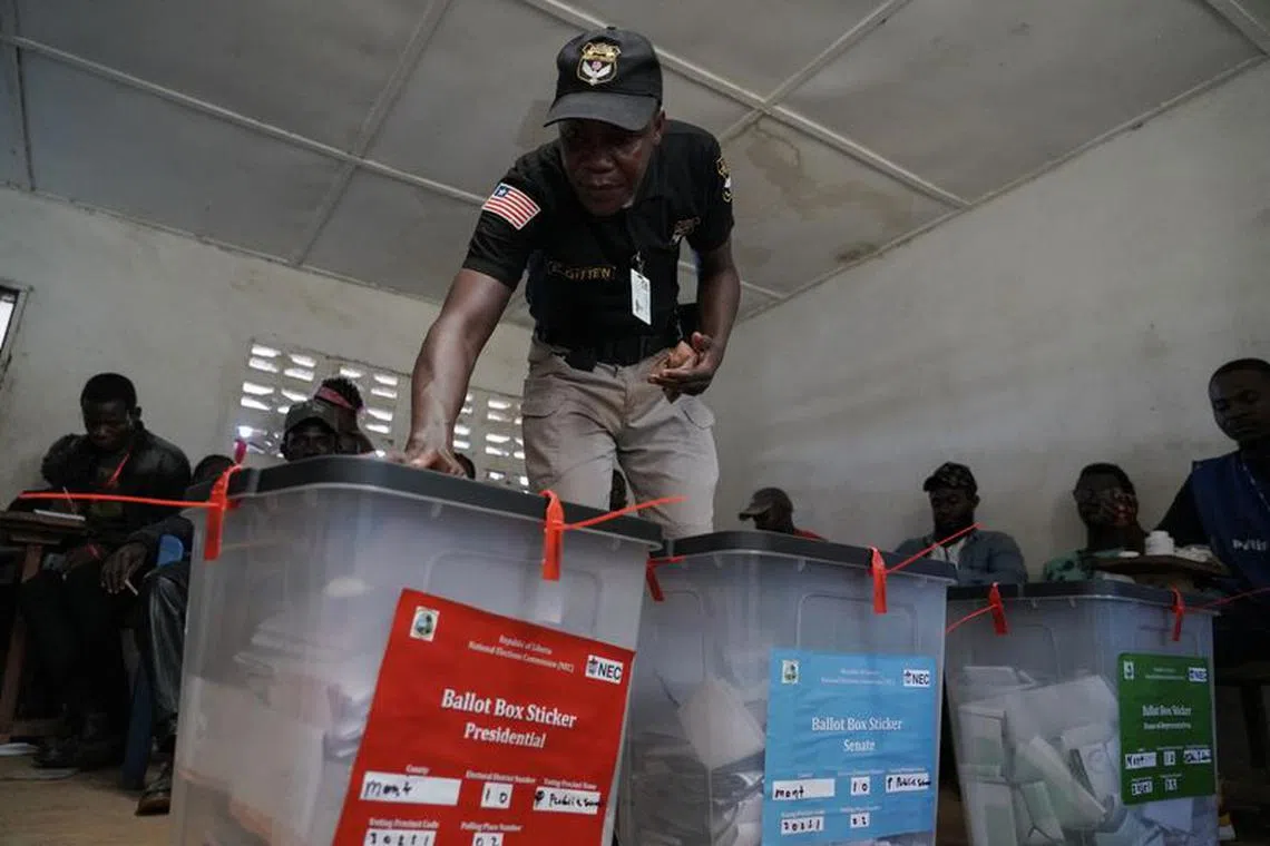 A security officer checkes ballot boxes  during Liberia's presidential election in Monrovia, Liberia October 10, 2023. REUTERS/Carielle Doe/File Photo