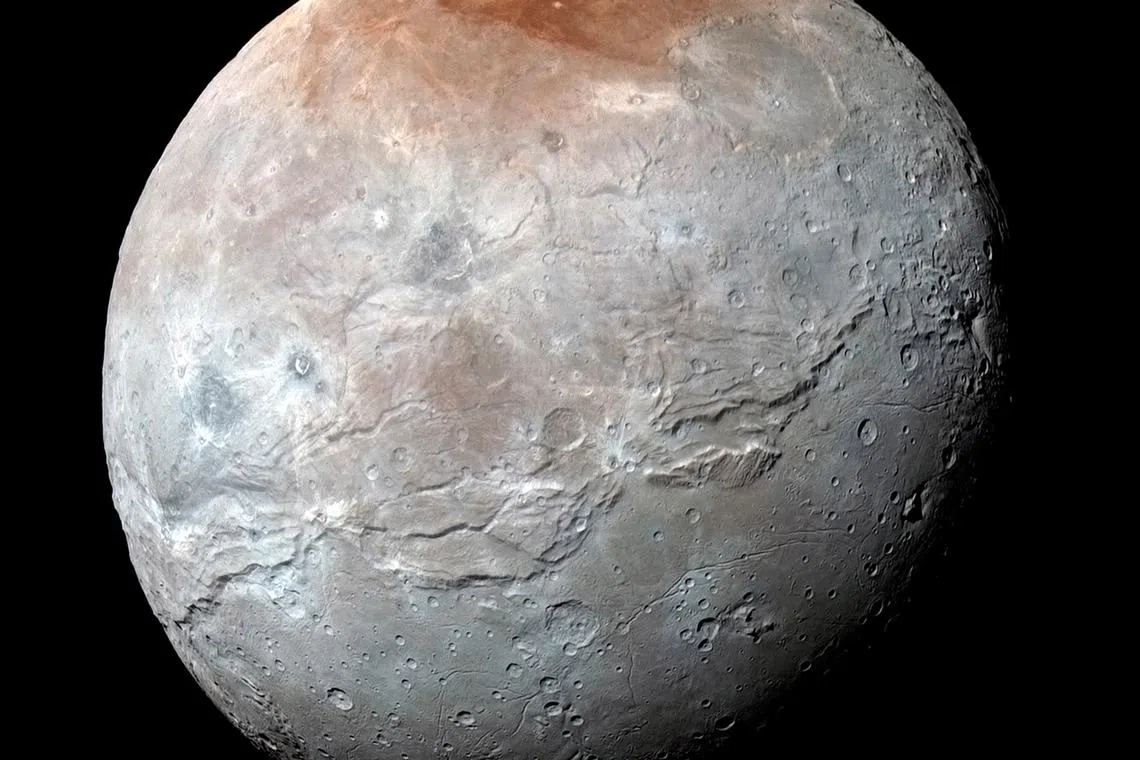 FILE PHOTO: Pluto's largest moon Charon is seen in a high-resolution, enhanced color view captured by NASA's New Horizons spacecraft on July 14, 2015 and released September 15, 2016.  NASA/JHUAPL/SwRI/Handout via Reuters/File Photo