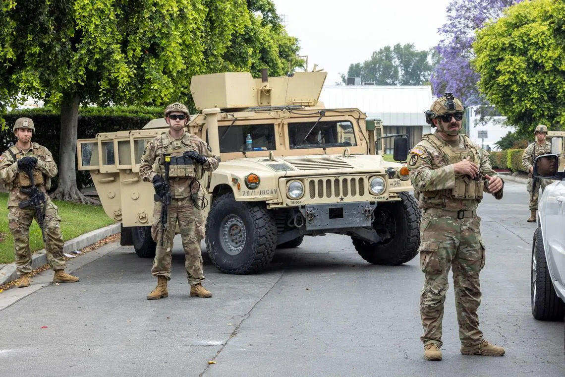 FILE PHOTO: Members of the California National Guard stand guard at the Paramount Business Center parking lot a day after clashes between protesters and law enforcement following multiple detentions by Immigration and Customs Enforcement (ICE), in the Los Angeles County city of Paramount, California, U.S., June 8, 2025.   REUTERS/Jill Connelly/File Photo