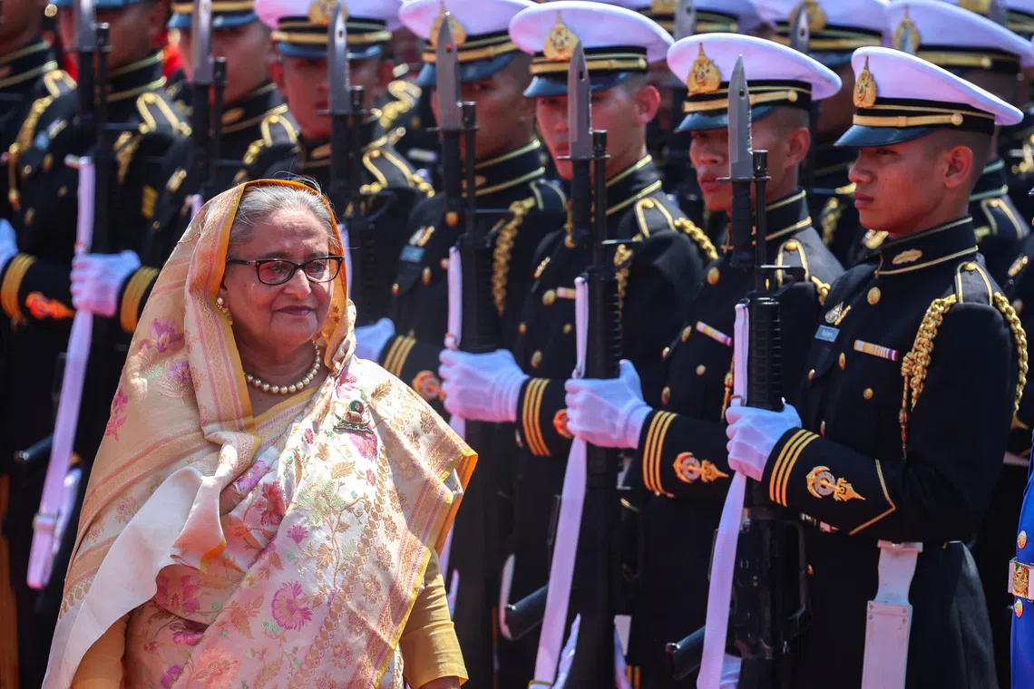 Sheikh Hasina reviews an honour guard at the Government House, during her visit to Thailand, in Bangkok, Thailand, April 26, 2024. REUTERS/Athit Perawongmetha