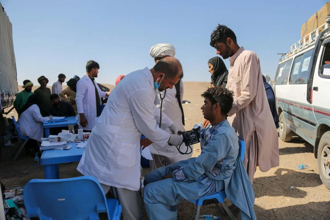 People receive medical treatment at a temporary clinic at earthquake-hit Zenda Jan district of Herat, Afghanistan, on Oct 12.
