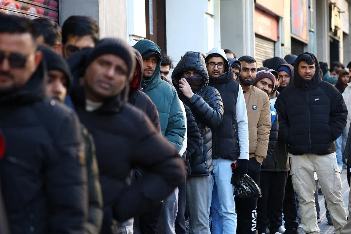 People queue outside Pakistan’s consulate in Barcelona to apply for criminal record certificates, a document required for the migrant regularisation programme recently announced by the Spanish government, in Barcelona, Spain. January 30, 2026. Spain plans to grant legal status to about half a million undocumented migrants. REUTERS/Albert Gea
