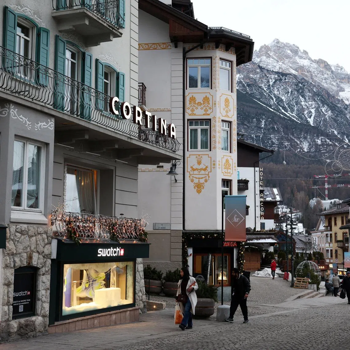 FILE PHOTO: People walk along a shopping street in downtown Cortina d'Ampezzo ahead of Milano Cortina Winter Olympic Games 2026, in Cortina d’Ampezzo, Italy, December 4, 2025. REUTERS/Claudia Greco/File Photo