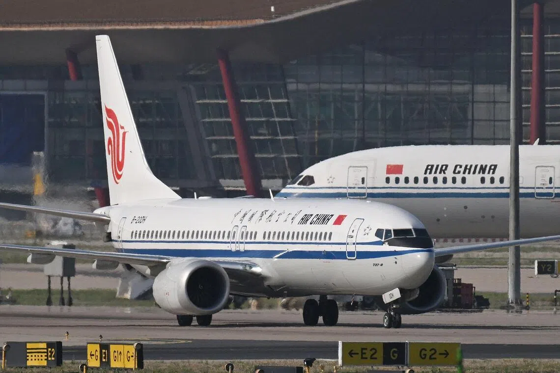 An Air China Boeing 737 MAX 8 taxis in front of an Air China Boeing 787-9 Dreamliner at Beijing Capital Airport in Beijing on May 8.