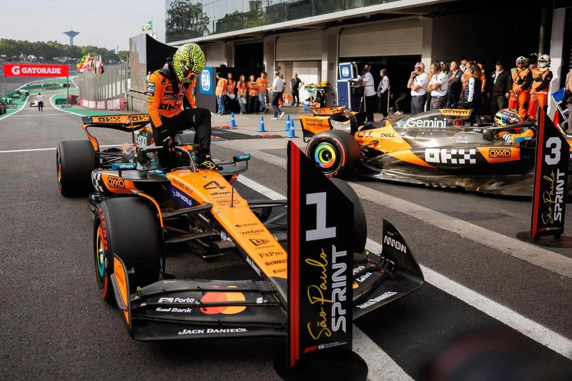 McLaren's Lando Norris climbing out of his car after securing pole position for the Sao Paulo Grand Prix Sprint.