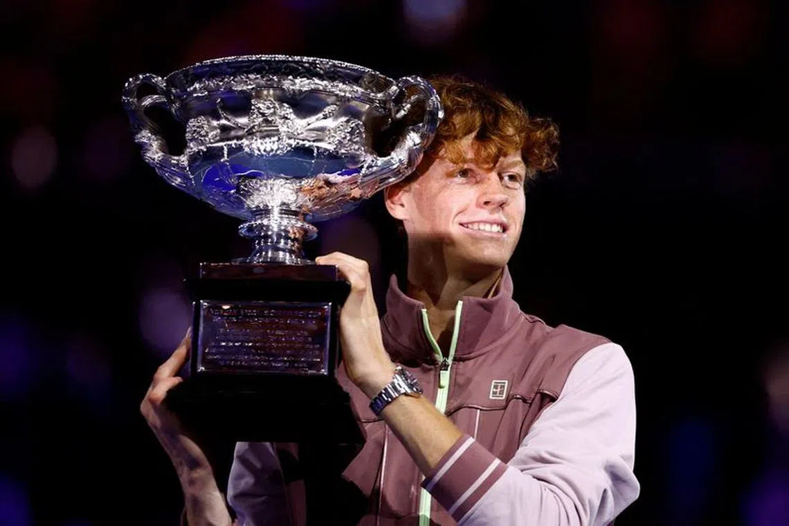 Tennis - Australian Open - Melbourne Park, Melbourne, Australia - January 28, 2024 Italy's Jannik Sinner celebrates with the trophy after winning the final against Russia's Daniil Medvedev REUTERS/Issei Kato