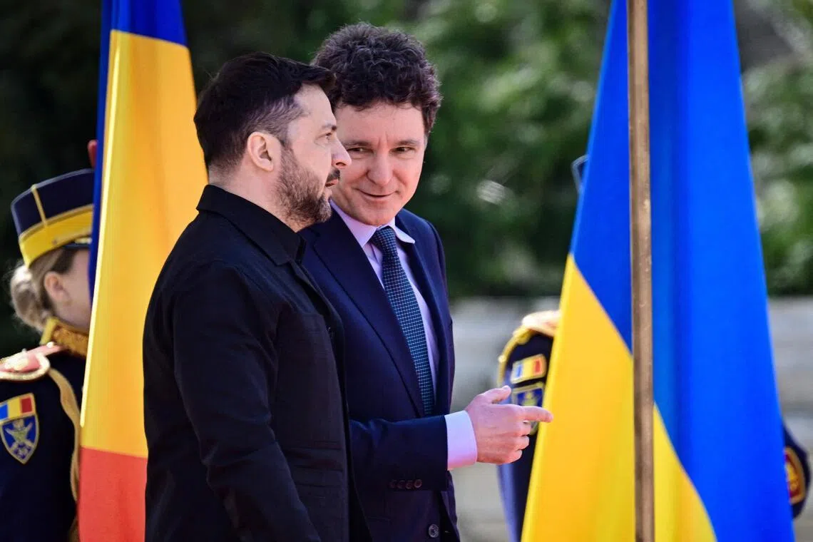 Romanian President Nicusor Dan (right) welcoming Ukrainian President Volodymyr Zelensky to Bucharest on March 12.