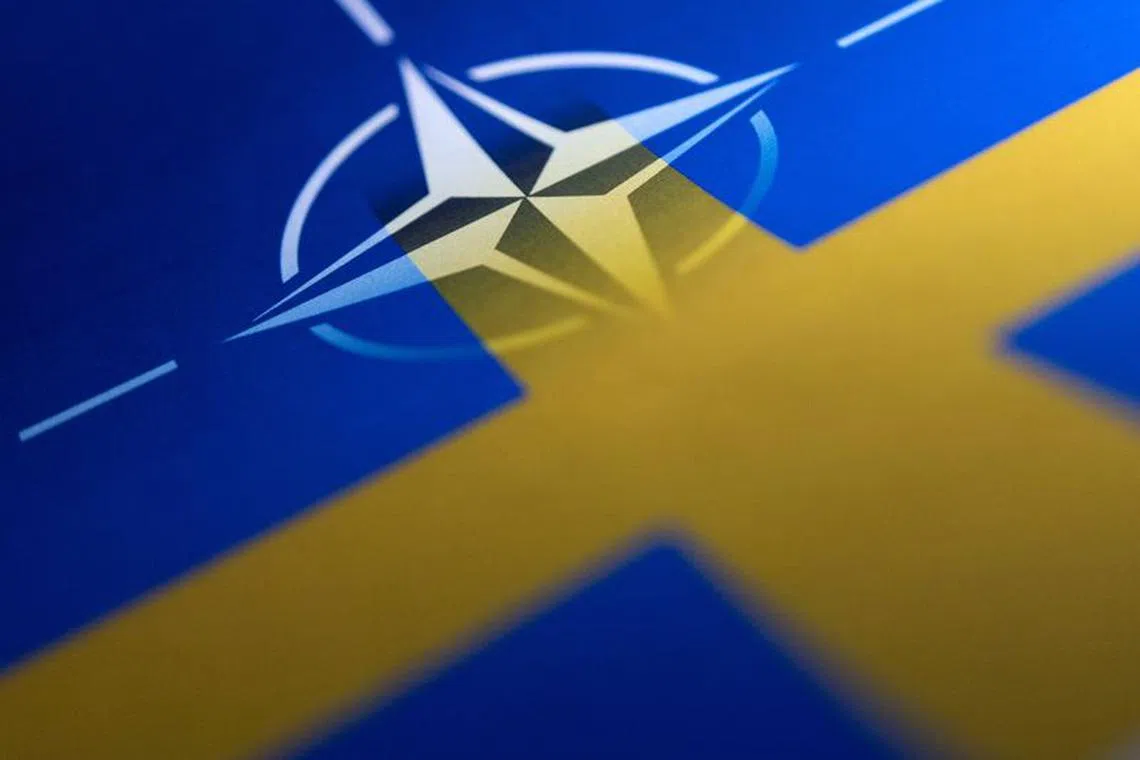 FILE PHOTO: Swedish and NATO flags are seen printed on paper this illustration taken April 13, 2022. REUTERS/Dado Ruvic/Illustration/File photo