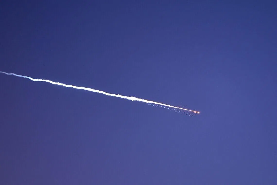 Rocket trails are seen in the sky above the Israeli coastal city of Netanya on March 28.