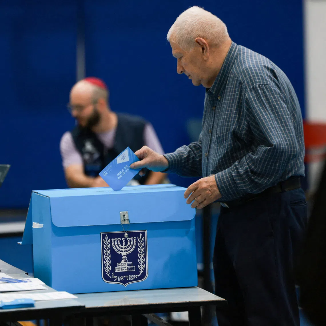An Israeli man votes at a polling station during Israel’s national election, in Jerusalem on Oct 27.