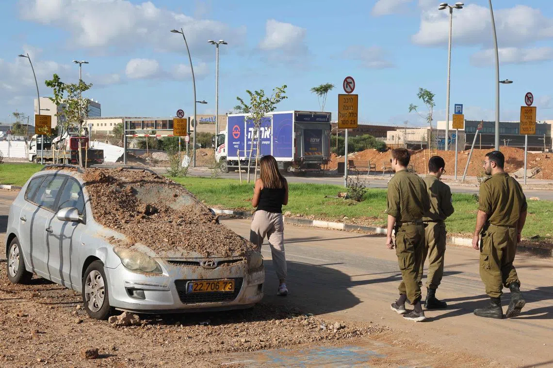 A damaged vehicle in the aftermath of an Iranian missile attack on Israel, on Oct 2, in Tel Aviv.