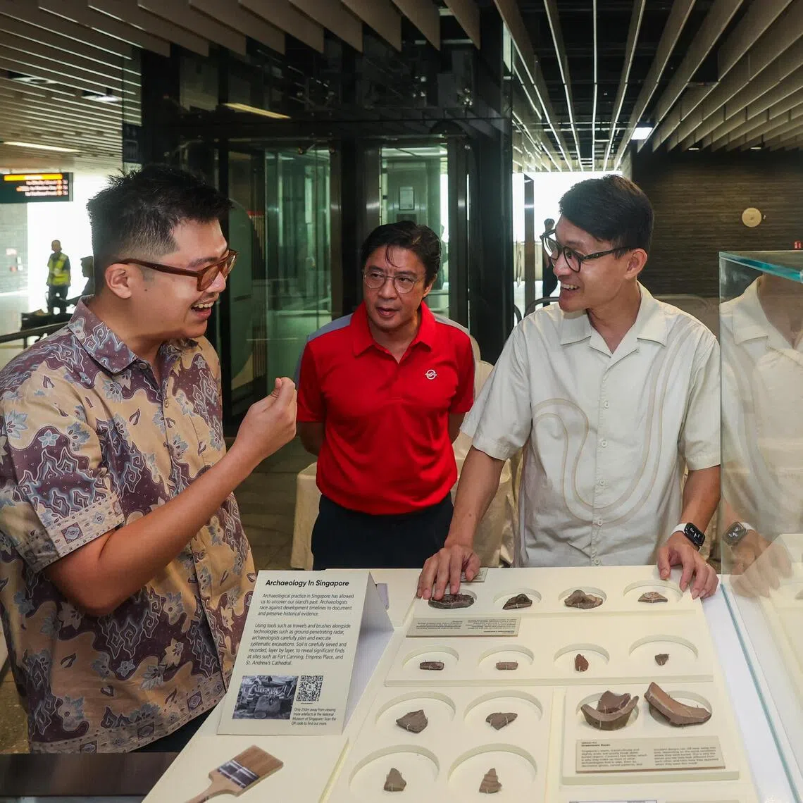 Mr Baey Yam Keng, Minister of State, Ministry of Culture, Community and Youth & Ministry of Transport viewing the artefacts accompanied by Alvin Kek Group Chief Commuter Engagement & Service Excellence introduced by Gerald Sim, Assistant Manager for Heritage Policy and Research at the National Heritage Board on Nov 19, 2025.