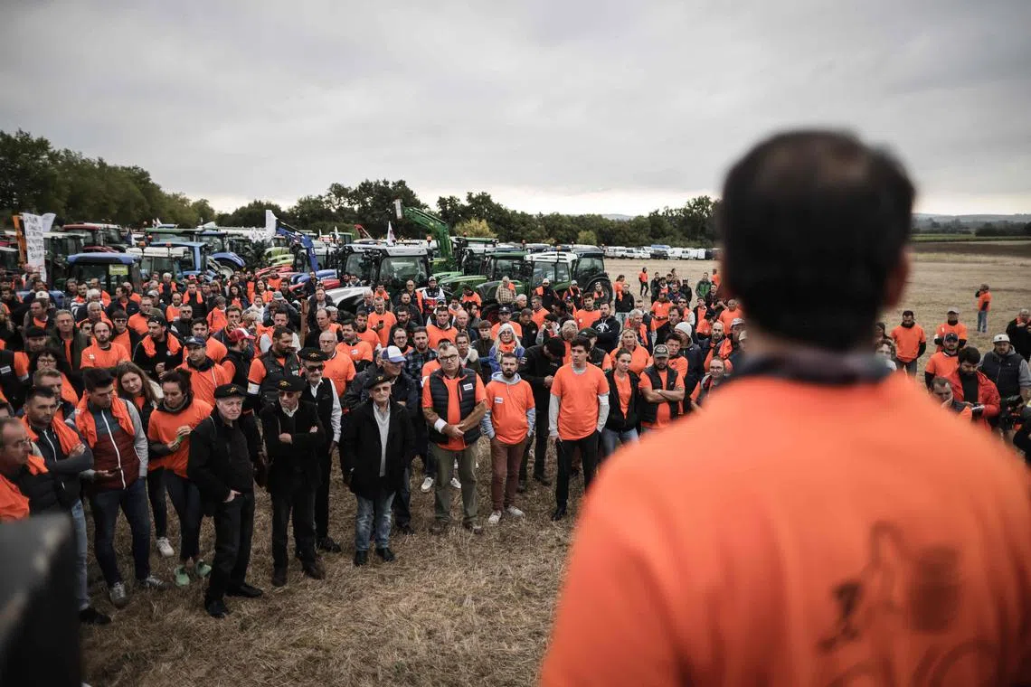 (FILES) Cognac winegrowers gather before a demonstration against the threat of Chinese taxes, in Gensac-la-Pallue, on September 17, 2024. Frustrated cognac producers in southwestern France are growing increasingly anxious over the looming threat of Chinese tariffs on European brandy, a move industry representatives worry could force French liquor from the Chinese market. Some 800 protestors riding on tractors and carrying signs gathered in France's southwestern town of Cognac on September 17, 2024, demanding a delay to an upcoming European Union vote to impose duties on Chinese electric vehicles. This protest,the first since 1998, comes after Beijing refused to rule out future tariffs following an anti-dumping investigation into brandy imported from the European Union. The probe was launched months after the EU undertook an investigation into Chinese electric vehicle (EV) subsidies. (Photo by Thibaud MORITZ / AFP)
