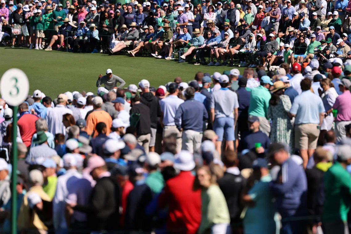 A huge crowd watching Tiger Woods lining up a putt on the second green during the second round of the Masters.