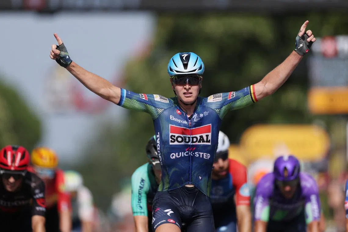Soudal Quick-Step’s Tim Merlier celebrates after crossing the finish line to win stage 8.