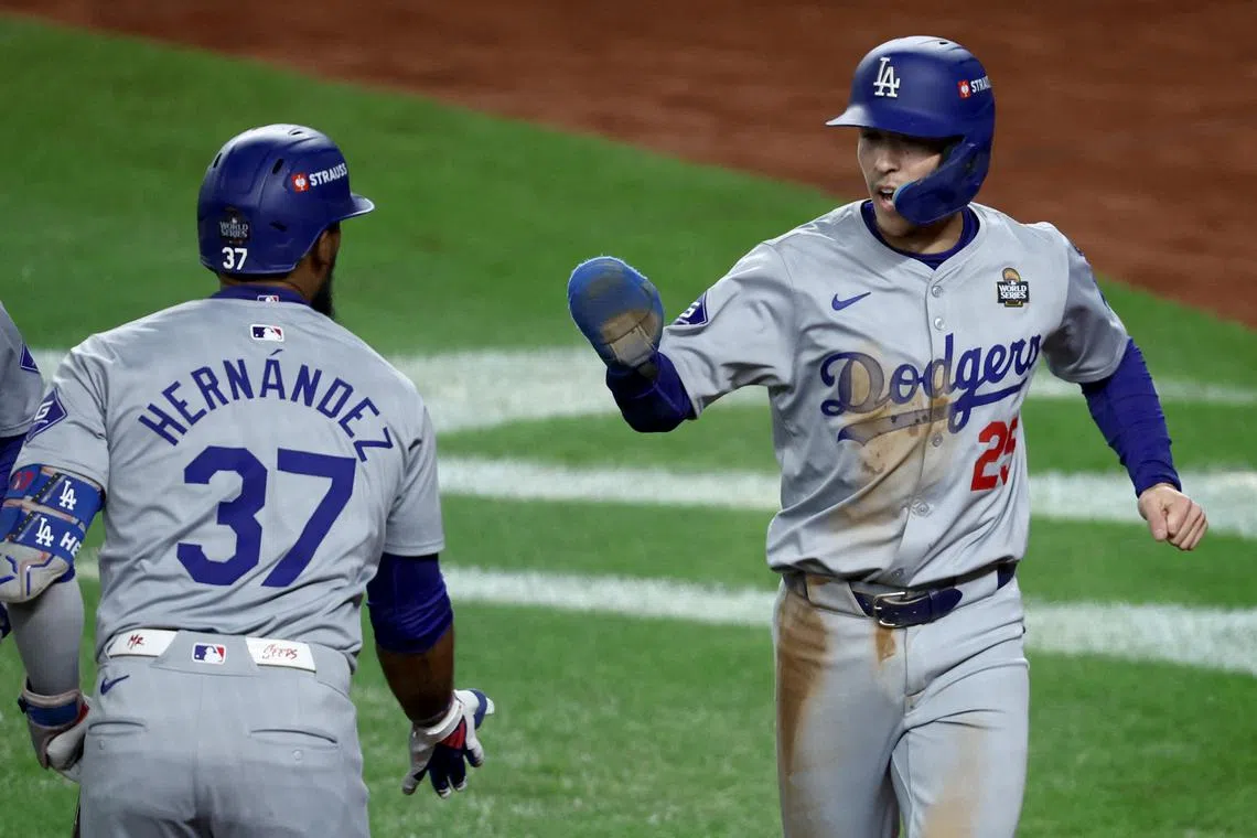 Oct 30, 2024; New York, New York, USA; Los Angeles Dodgers outfielder Tommy Edman (25) celebrates with outfielder Teoscar Hernandez (37) after scoring the go-ahead run during the eighth inning against the New York Yankees in game five of the 2024 MLB World Series at Yankee Stadium. Mandatory Credit: Wendell Cruz-Imagn Images/ File Photo