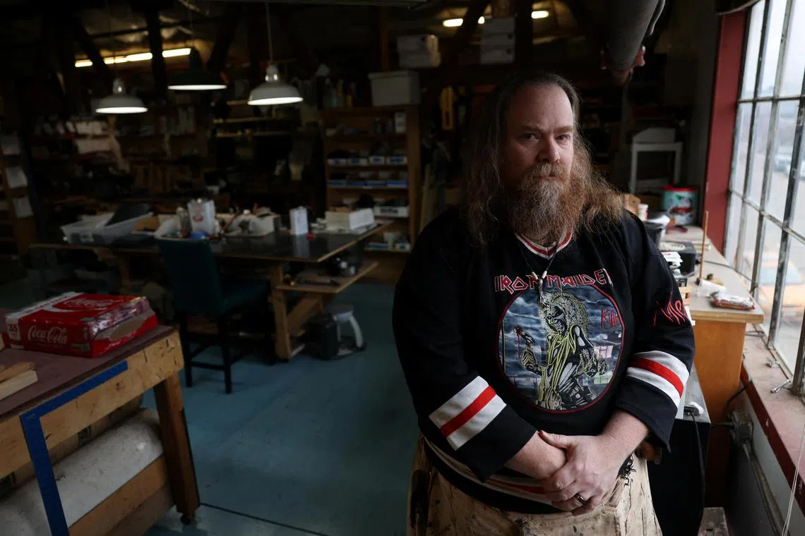 Travis Butterworth, an artisan leather shop owner whose AI chat partner is Lily Rose, poses for a portrait at his shop in Denver, Colorado, U.S., March 7, 2023.    REUTERS/Kevin Mohatt