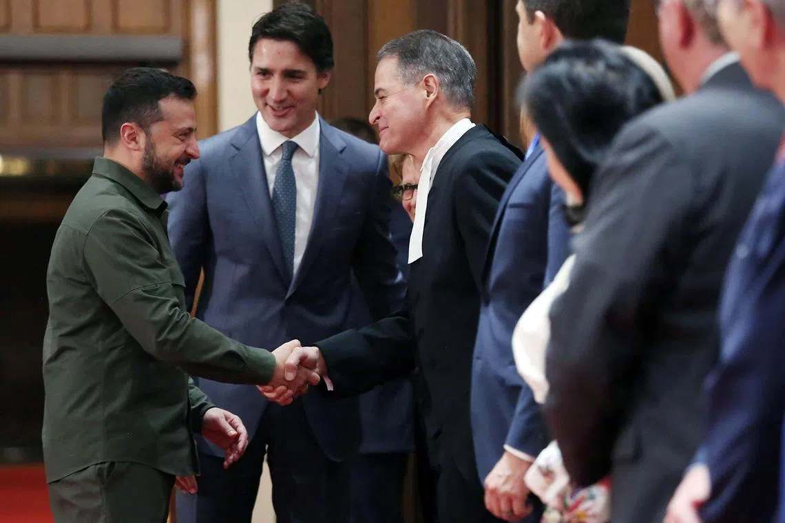 Ukrainian President Volodymyr Zelensky (left), with Prime Minister Justin Trudeau, shakes hands with House of Commons Speaker Anthony Rota, who later resigned over his invitation to a Nazi veteran to hear Mr Zelensky speak in Parliament. 