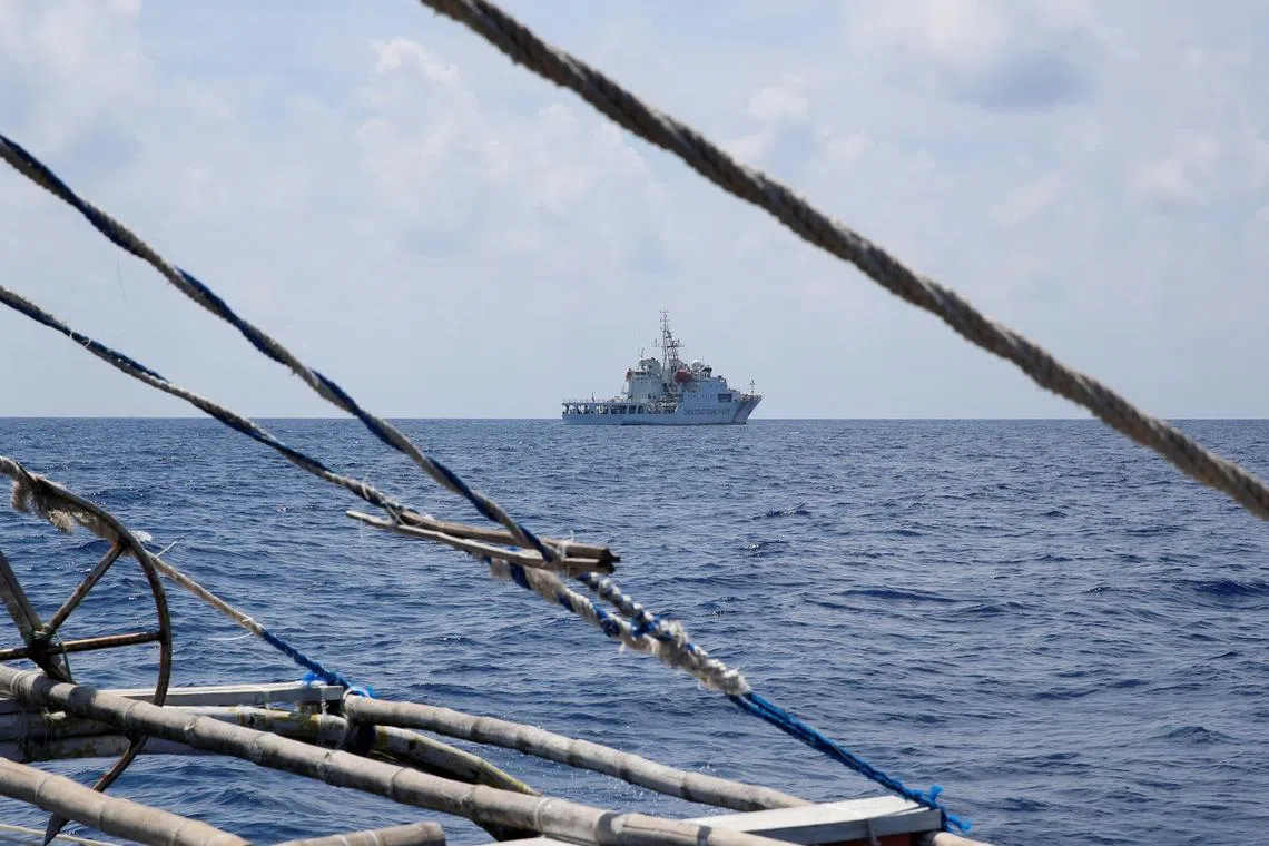 A Chinese coast guard ship is seen from a fishing boat at Scarborough Shoal, which China seized in 2012 after a tense stand-off with the Philippines.