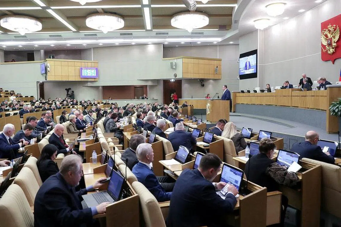 Deputies attend a plenary session of the State?Duma, the lower house of parliament, to discuss a bill allowing the confiscation of property from those convicted of a number of crimes including spreading \"deliberately false information\" about the Russian army, in Moscow, Russia January 24, 2024. Russian State Duma/Handout via REUTERS/File Photo