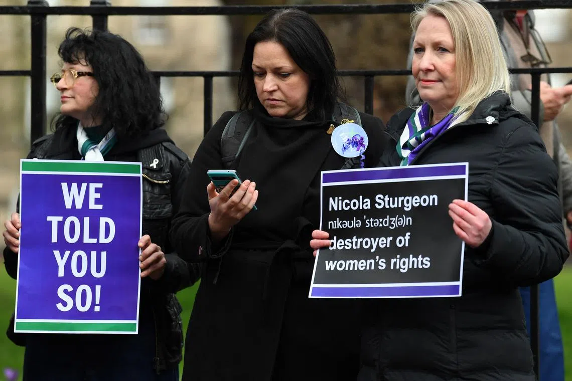 Demonstrators holding placards during a protest outside of Bute House, as Scotland's First Minister Nicola Sturgeon announced her resignation on February 15, 2023. 