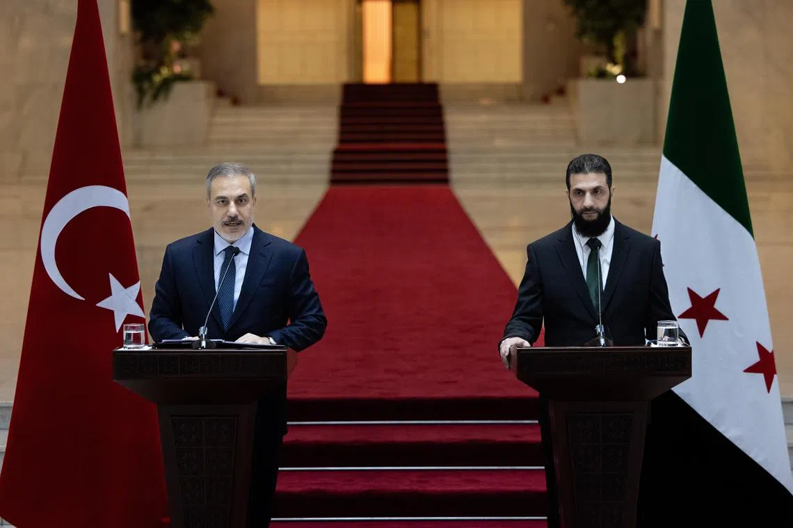 Visiting Turkish Foreign Minister Hakan Fidan (left) and Syria's rebel leader, Mr Ahmed al-Sharaa, delivering a press conference after their meeting in Damascus, on Dec 22.