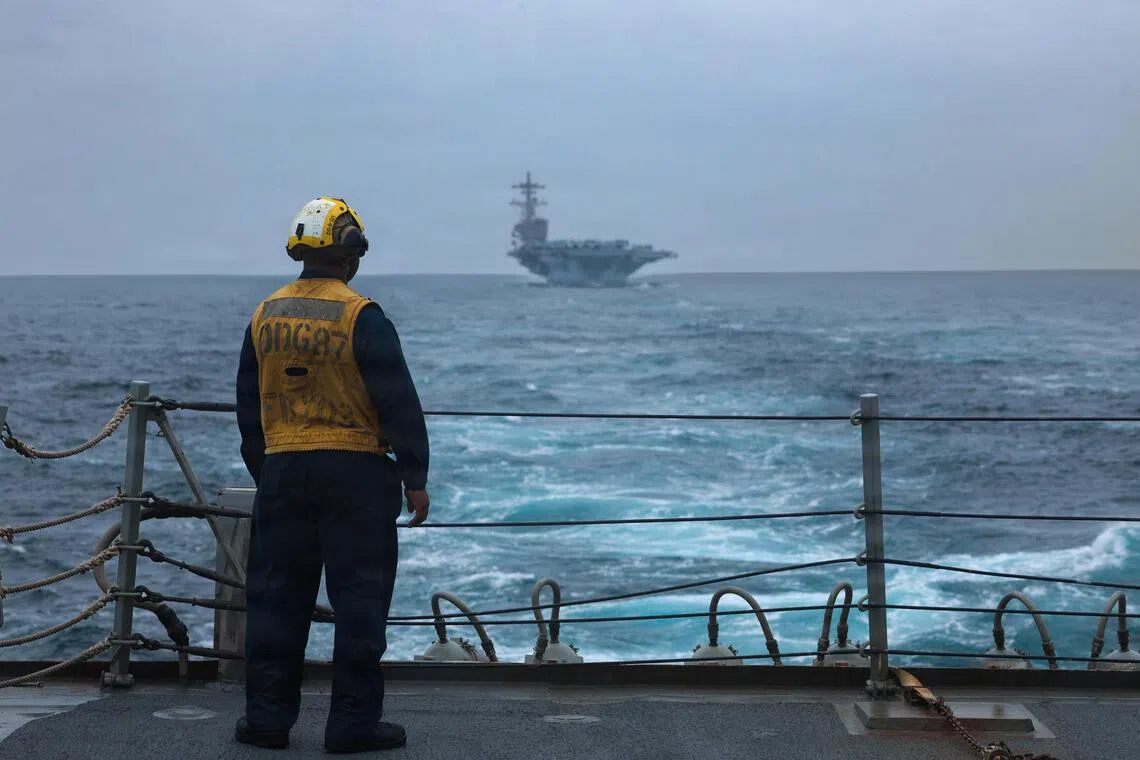 This US Navy handout photograph released by US Naval Forces A US sailor standing on the flight deck of the guided-missile destroyer USS Mason, in a photo released by the US Navy.
