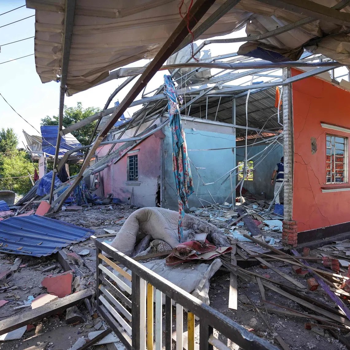 A house damaged after Thai military strikes in Cambodia's Banteay Meanchey province on Dec 16, amid clashes between Thailand and Cambodia along a disputed border.