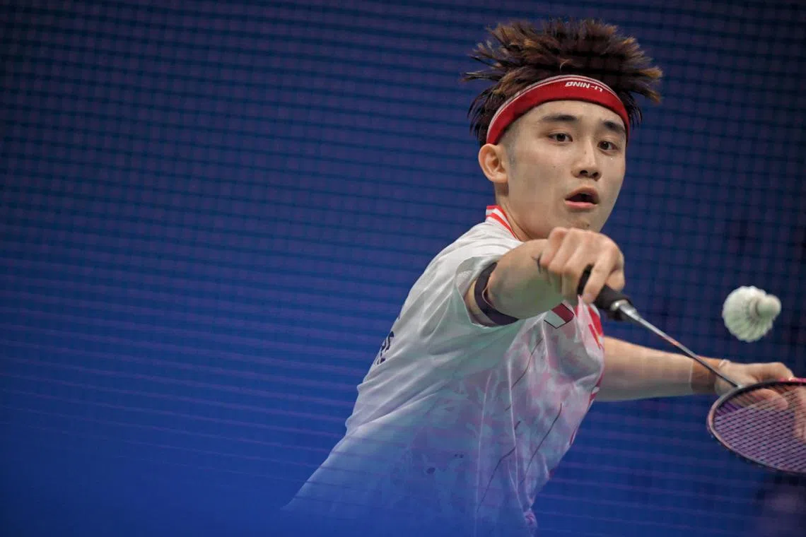 Jason Teh of Singapore in action against Kanta Tsuneyama of Japan during the 19th Asian Games Badminton Men’s Team Round of 16 held at the Binjiang Gymnasium on Sept 28, 2023.