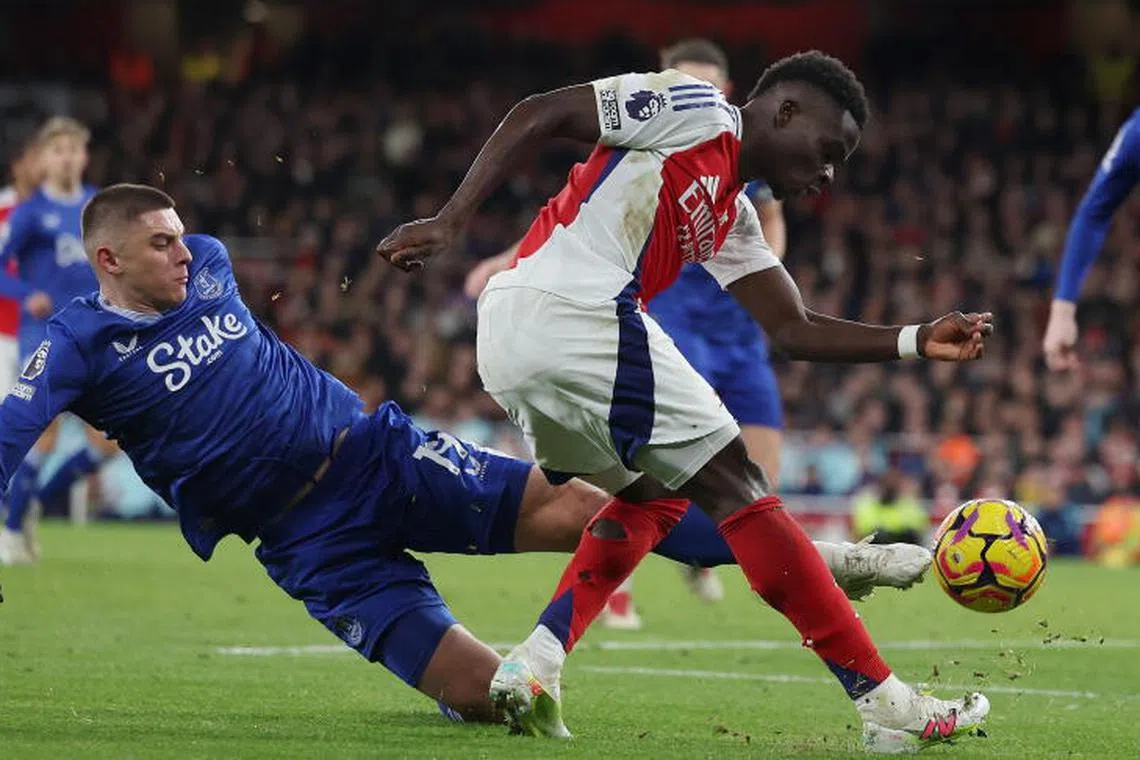 Everton's Vitalii Mykolenko (L) and Arsenal's Bukayo Saka (R) in action during the English Premier League soccer match between Arsenal FC and Everton FC, in London, Britain, 14 December 2024. EPA-EFE/ANDY RAIN